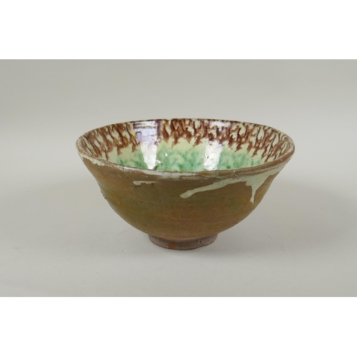 91 - An Islamic earthenware bowl with sponged decoration, 21cm diameter