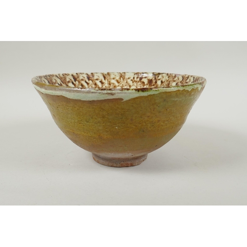 91 - An Islamic earthenware bowl with sponged decoration, 21cm diameter