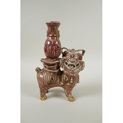 93 - A Chinese flambe glazed porcelain spill vase in the form of a temple lion, 23cm high