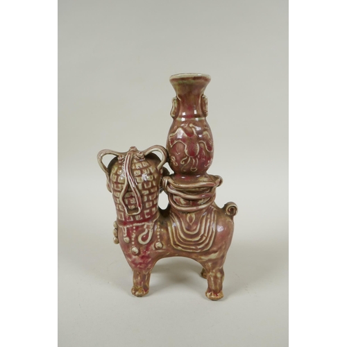 93 - A Chinese flambe glazed porcelain spill vase in the form of a temple lion, 23cm high