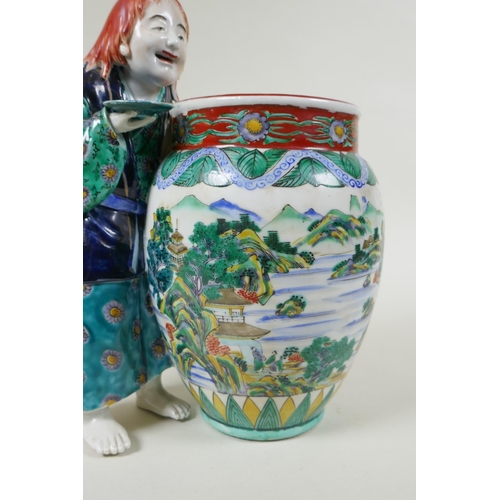 95 - A Japanese Kutani porcelain vase with a figure, the vase decorated with a riverside landscape, marke... 