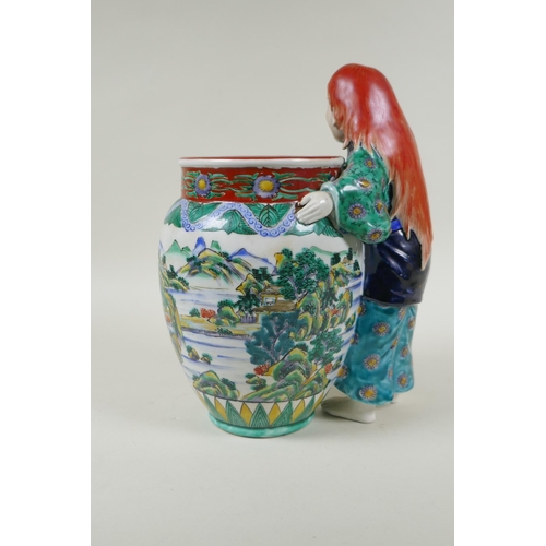 95 - A Japanese Kutani porcelain vase with a figure, the vase decorated with a riverside landscape, marke... 