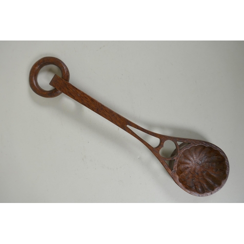 98 - A Welsh hand carved and pierced fruit wood love spoon, 28cm long