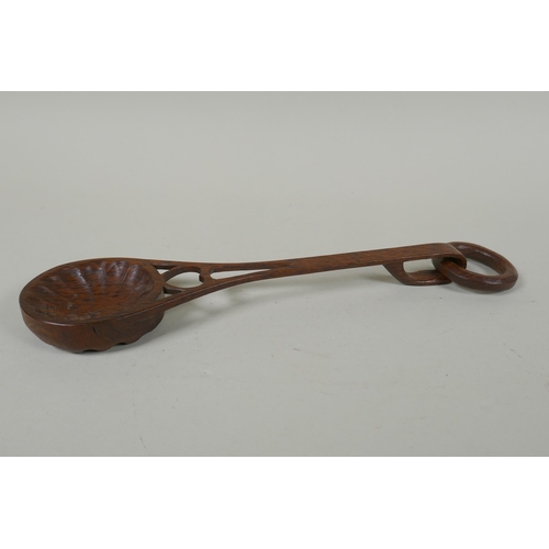 98 - A Welsh hand carved and pierced fruit wood love spoon, 28cm long