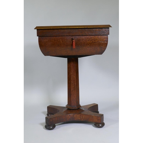 1003 - A Victorian oak workbox, the lift up top with fitted interior, raised on a tapering column and platf... 