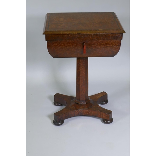 1003 - A Victorian oak workbox, the lift up top with fitted interior, raised on a tapering column and platf... 