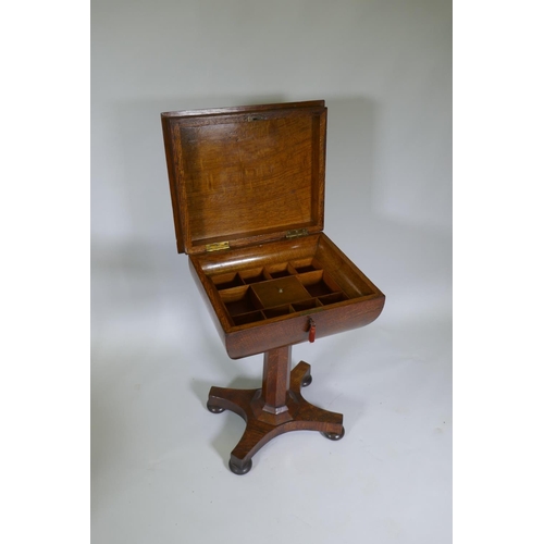 1003 - A Victorian oak workbox, the lift up top with fitted interior, raised on a tapering column and platf... 