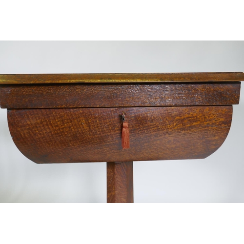 1003 - A Victorian oak workbox, the lift up top with fitted interior, raised on a tapering column and platf... 