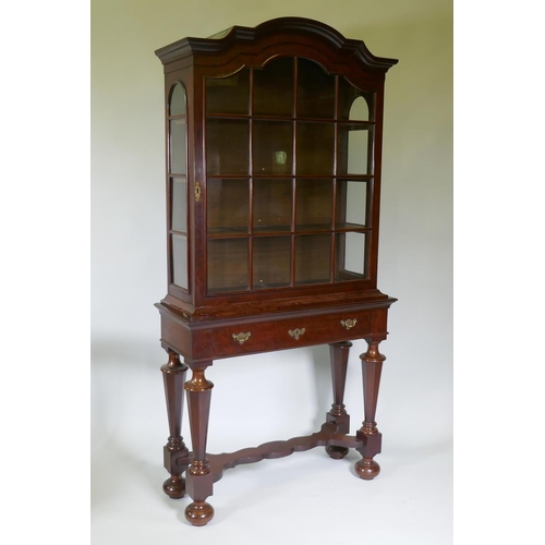 1005 - A C19th Dutch mahogany dome topped glazed display cabinet, with single door on a base with one long ... 