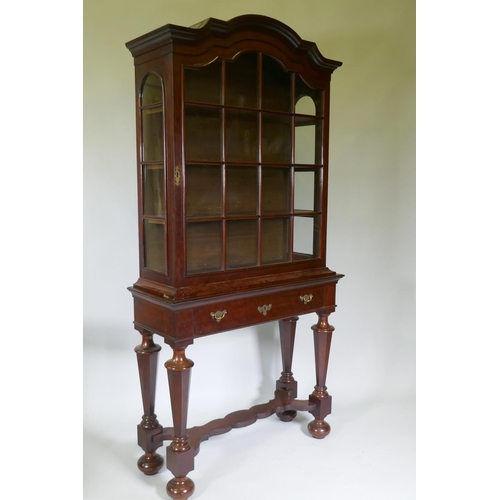 1005 - A C19th Dutch mahogany dome topped glazed display cabinet, with single door on a base with one long ... 