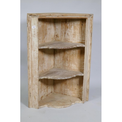 1010 - A C19th stripped pine hanging corner shelf, 66cm wide x 92cm high