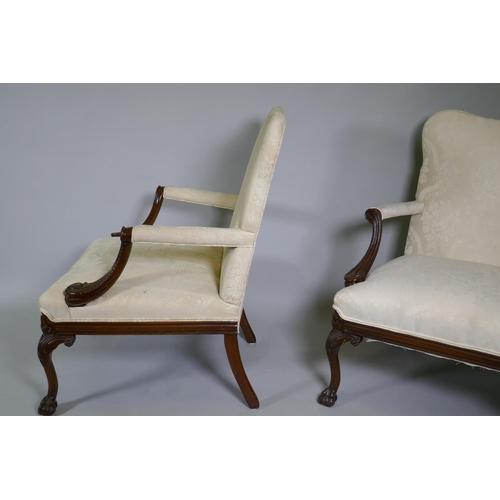 1012 - A pr of C18th style Gainsborough chairs with carved decoration and hump backs, raised on cabriole su... 