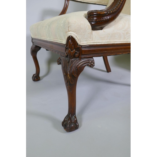 1012 - A pr of C18th style Gainsborough chairs with carved decoration and hump backs, raised on cabriole su... 