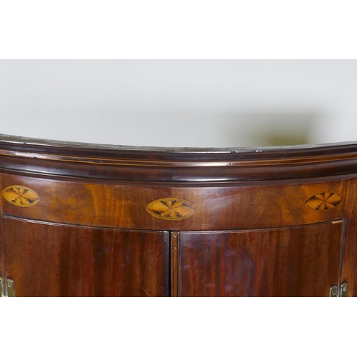 1018 - A Georgian mahogany bow fronted hanging corner cupboard, with inlaid decoration, H hinges and decora... 