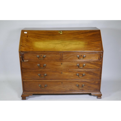 1022 - A Georgian mahogany bureau, the fall front with inset leather opening to reveal a fitted interior wi... 