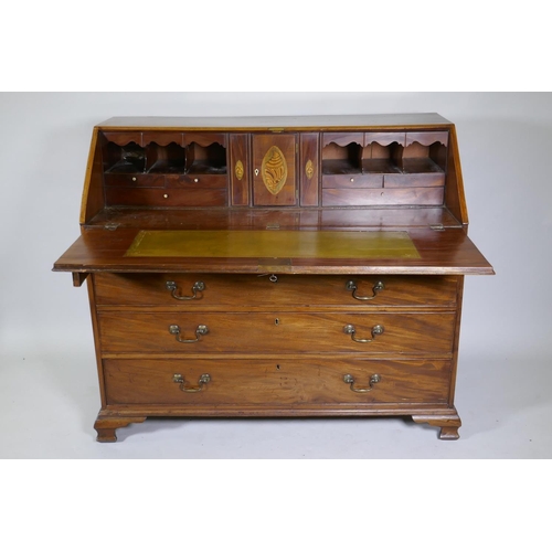 1022 - A Georgian mahogany bureau, the fall front with inset leather opening to reveal a fitted interior wi... 