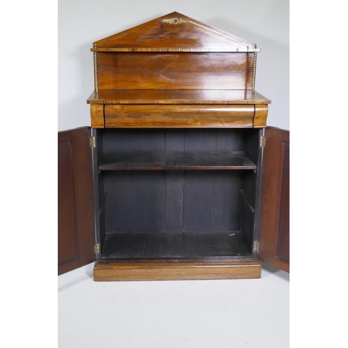 1023 - A small Regency rosewood chiffonier with brass stringing and mounts, the upper shelf raised on twist... 