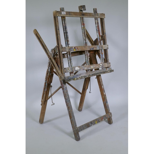 1025 - A well used wooden folding artist's easel, 62cm wide