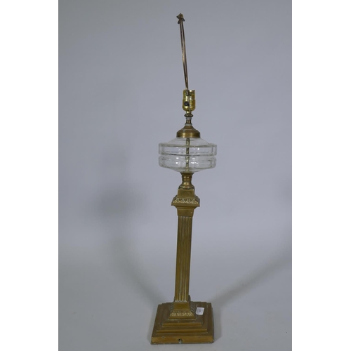 103 - A Victorian brass oil lamp with cut glass reservoir, converted to electricity, 88cm high