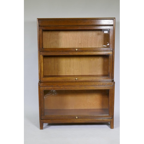 1032 - A Globe Wernicke style oak bookcase, two upper sections over a stepped lower, AF glass cracked, 87 x... 