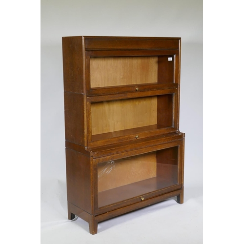 1032 - A Globe Wernicke style oak bookcase, two upper sections over a stepped lower, AF glass cracked, 87 x... 