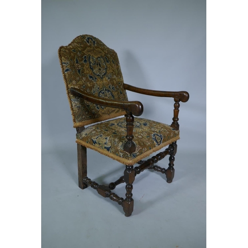 1033 - A C17th William and Mary walnut humpback open armchair on turned supports, circa 1690, historic repa... 