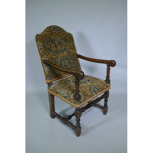 1033 - A C17th William and Mary walnut humpback open armchair on turned supports, circa 1690, historic repa... 