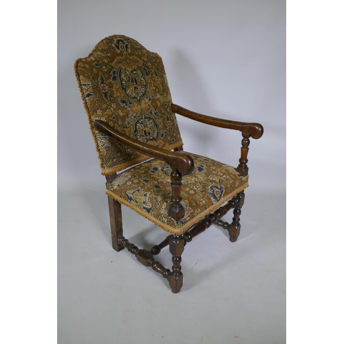 1033 - A C17th William and Mary walnut humpback open armchair on turned supports, circa 1690, historic repa... 