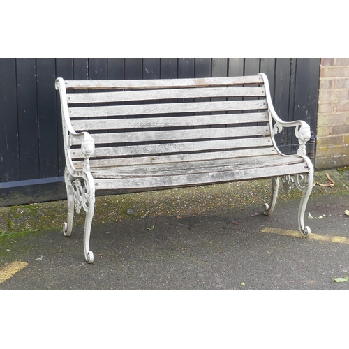 1040 - A painted metal garden bench with lion mask decoration, 126cm wide