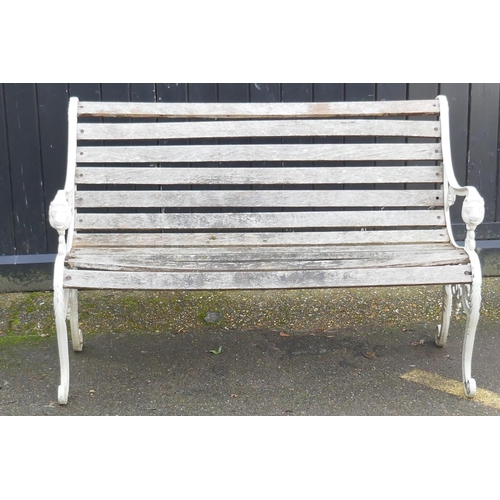 1040 - A painted metal garden bench with lion mask decoration, 126cm wide