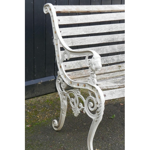 1040 - A painted metal garden bench with lion mask decoration, 126cm wide