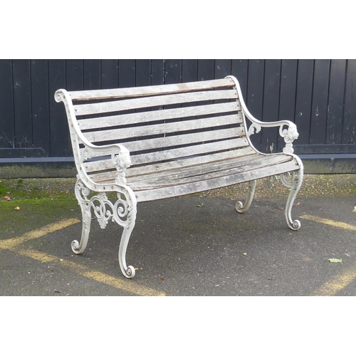 1040 - A painted metal garden bench with lion mask decoration, 126cm wide