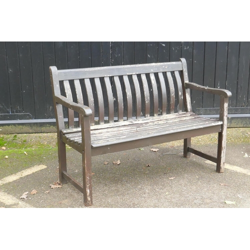 1042 - A varnished teak garden bench, 123cm wide