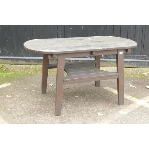 1043 - A varnished teak garden table with undertier, 137 x 70cm