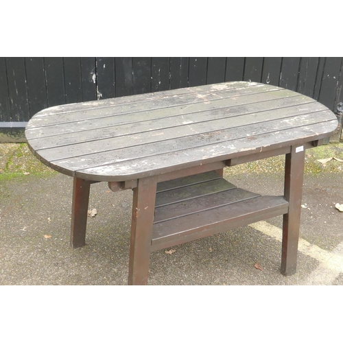 1043 - A varnished teak garden table with undertier, 137 x 70cm