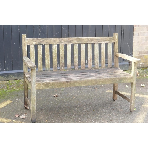 1045 - A weathered teak garden bench, 125cm wide