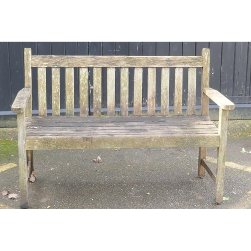 1045 - A weathered teak garden bench, 125cm wide