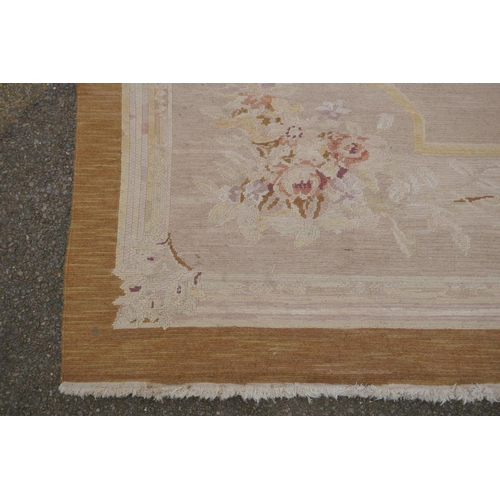 1053 - An antique French beige ground wool Savonnerie rug, 242 x 296cm