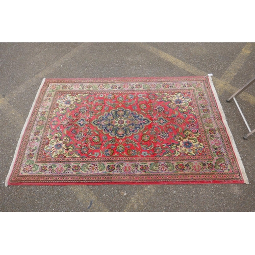 1059 - A very fine hand woven Persian Kashan rug with floral medallion design on a pink field, patched, 172... 