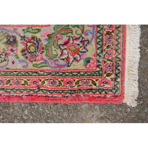 1059 - A very fine hand woven Persian Kashan rug with floral medallion design on a pink field, patched, 172... 