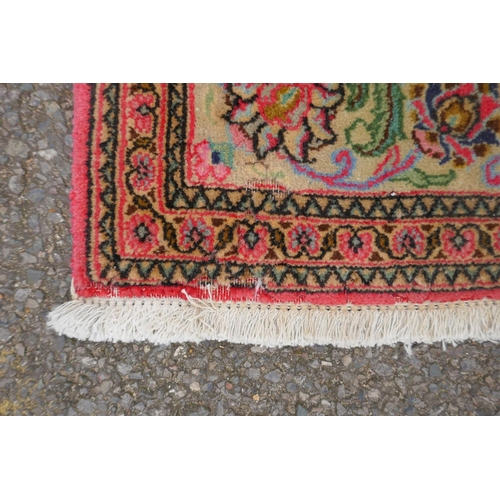 1059 - A very fine hand woven Persian Kashan rug with floral medallion design on a pink field, patched, 172... 