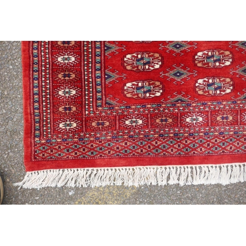 1068 - A rich red ground fine woven Bokhara runner, 98 x 364cm