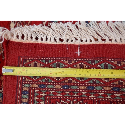 1068 - A rich red ground fine woven Bokhara runner, 98 x 364cm