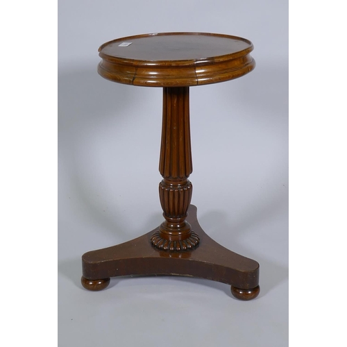 1076 - A C19th mahogany wine table, raised on Gillow style reeded column and platform base with bun support... 