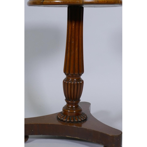 1076 - A C19th mahogany wine table, raised on Gillow style reeded column and platform base with bun support... 