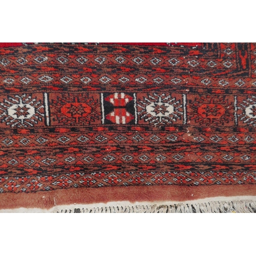 1078 - A red ground Bokhara rug with brown and orange borders, 128 x 175cm