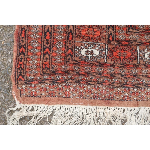 1078 - A red ground Bokhara rug with brown and orange borders, 128 x 175cm