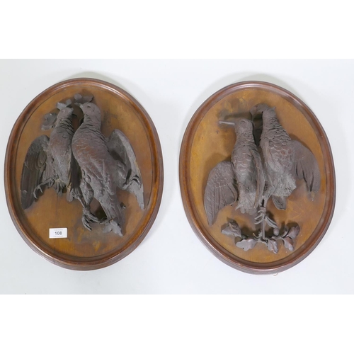 108 - A pair of C19th oak wall plaques with finely carved braces of woodland birds, 46 x 36cm