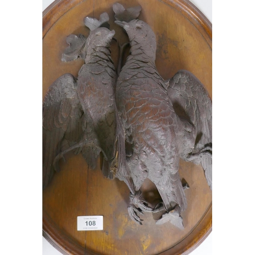 108 - A pair of C19th oak wall plaques with finely carved braces of woodland birds, 46 x 36cm