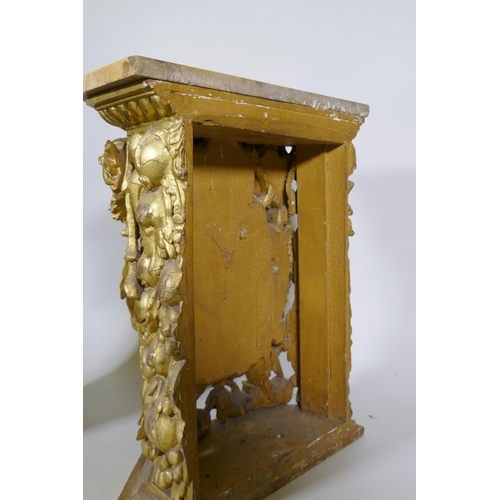 1084 - A pair of early C19th carved and giltwood pine pedestals/stands, decorated with winged putti and she... 